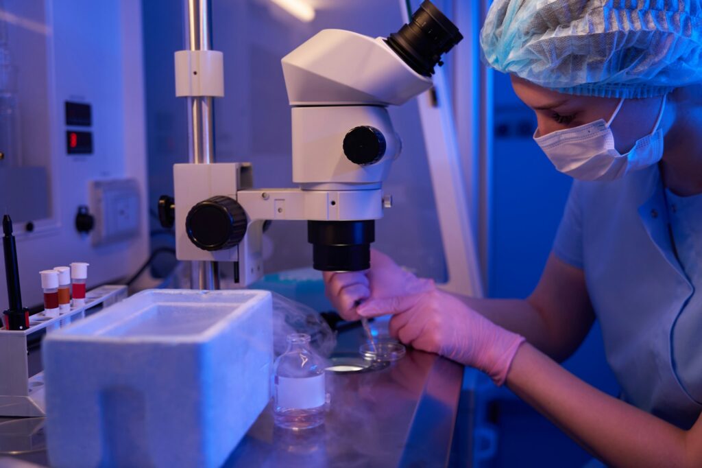Female scientist preparing biological material for cryopreservation